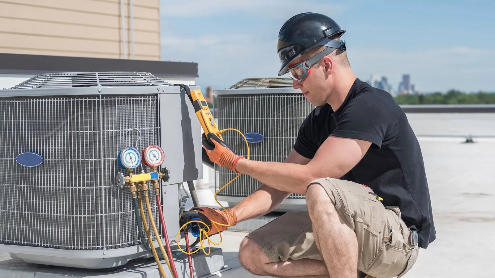 An HVAC technician servicing an outdoor AC unit